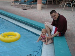 Father and daughter at pool