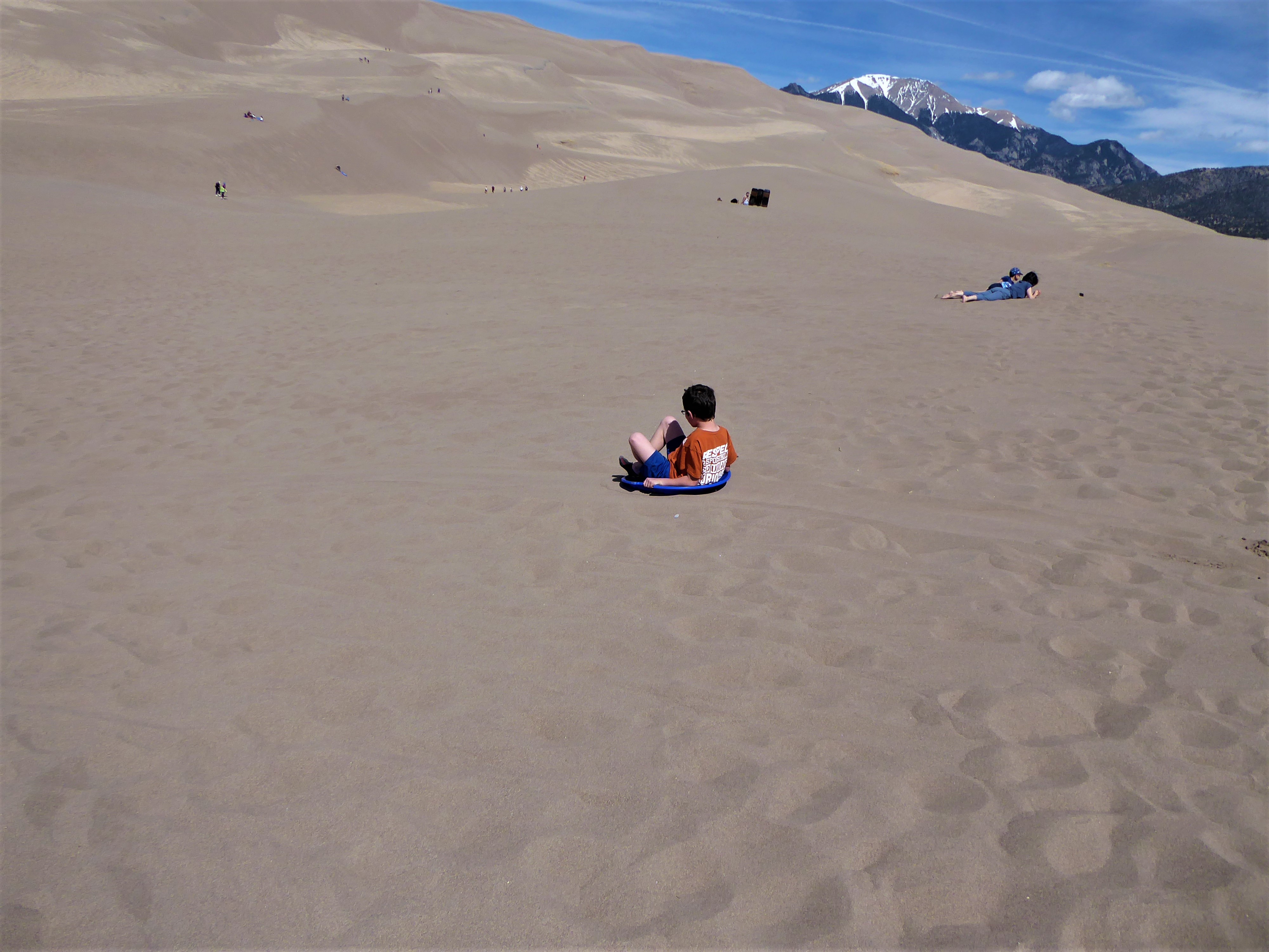 Great Sand Dunes boy sledding