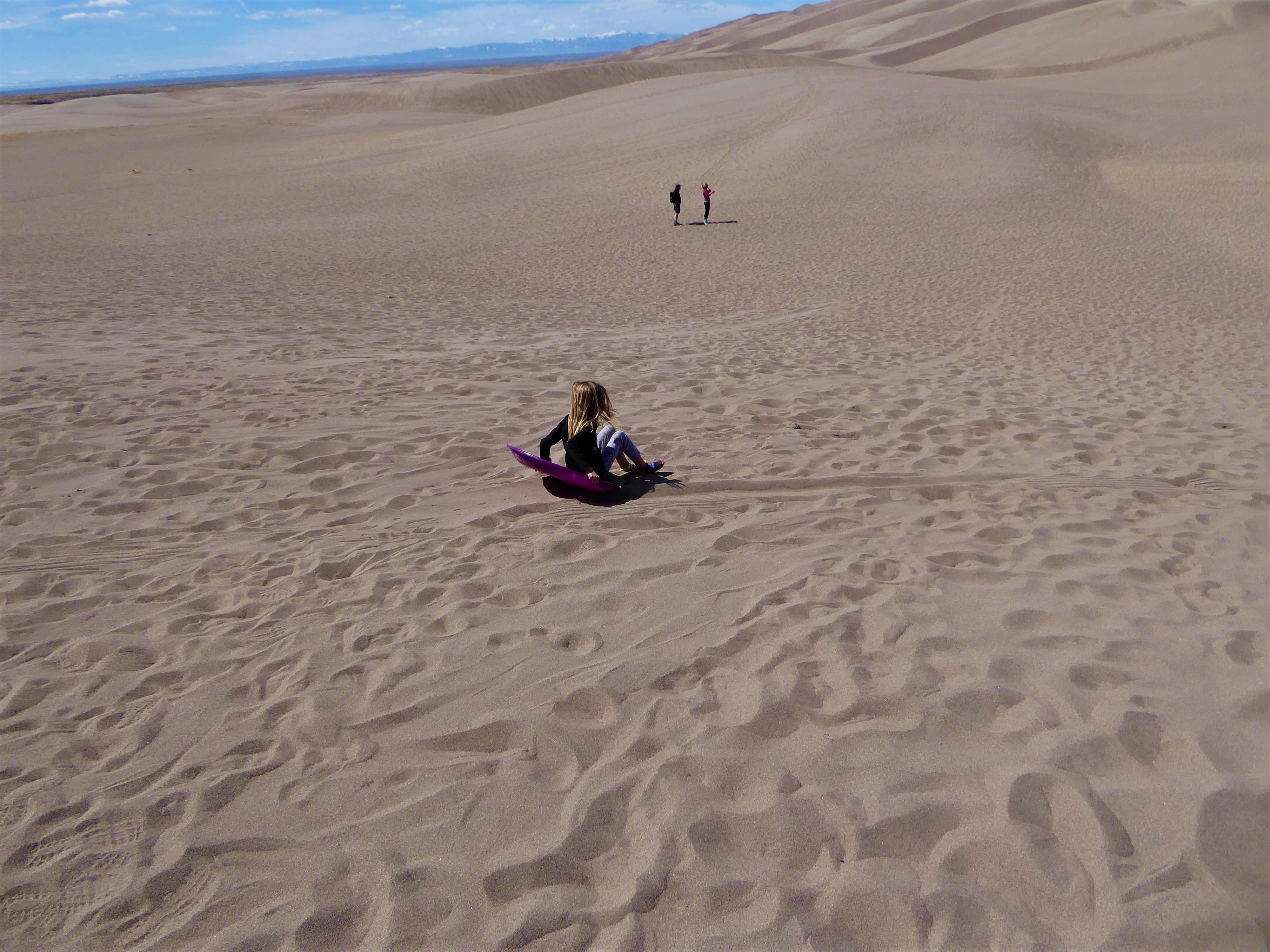 Great Sand Dunes girl sledding