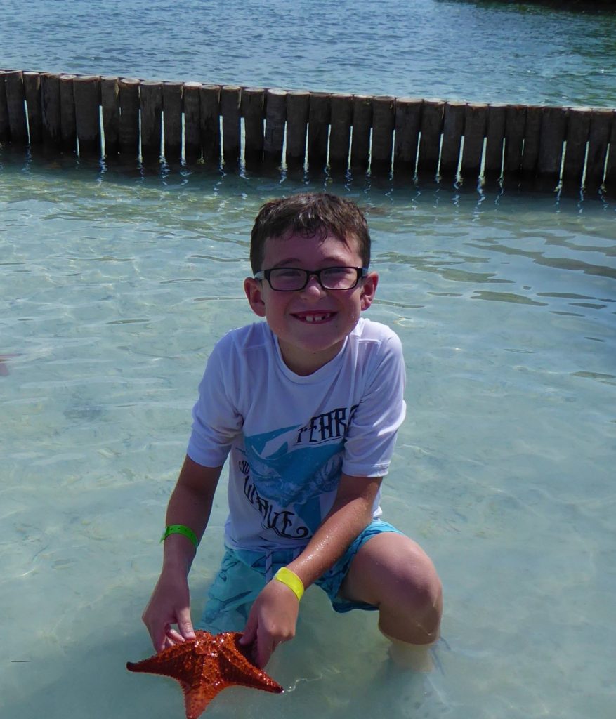 Starfish Island Belize Holding a Starfish